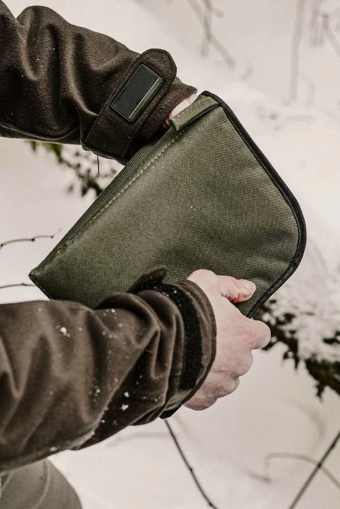 stabilotherm seat pad gruen als sitzkissen im schnee beim wintereinsatz fuer outdoor aktivitaeten